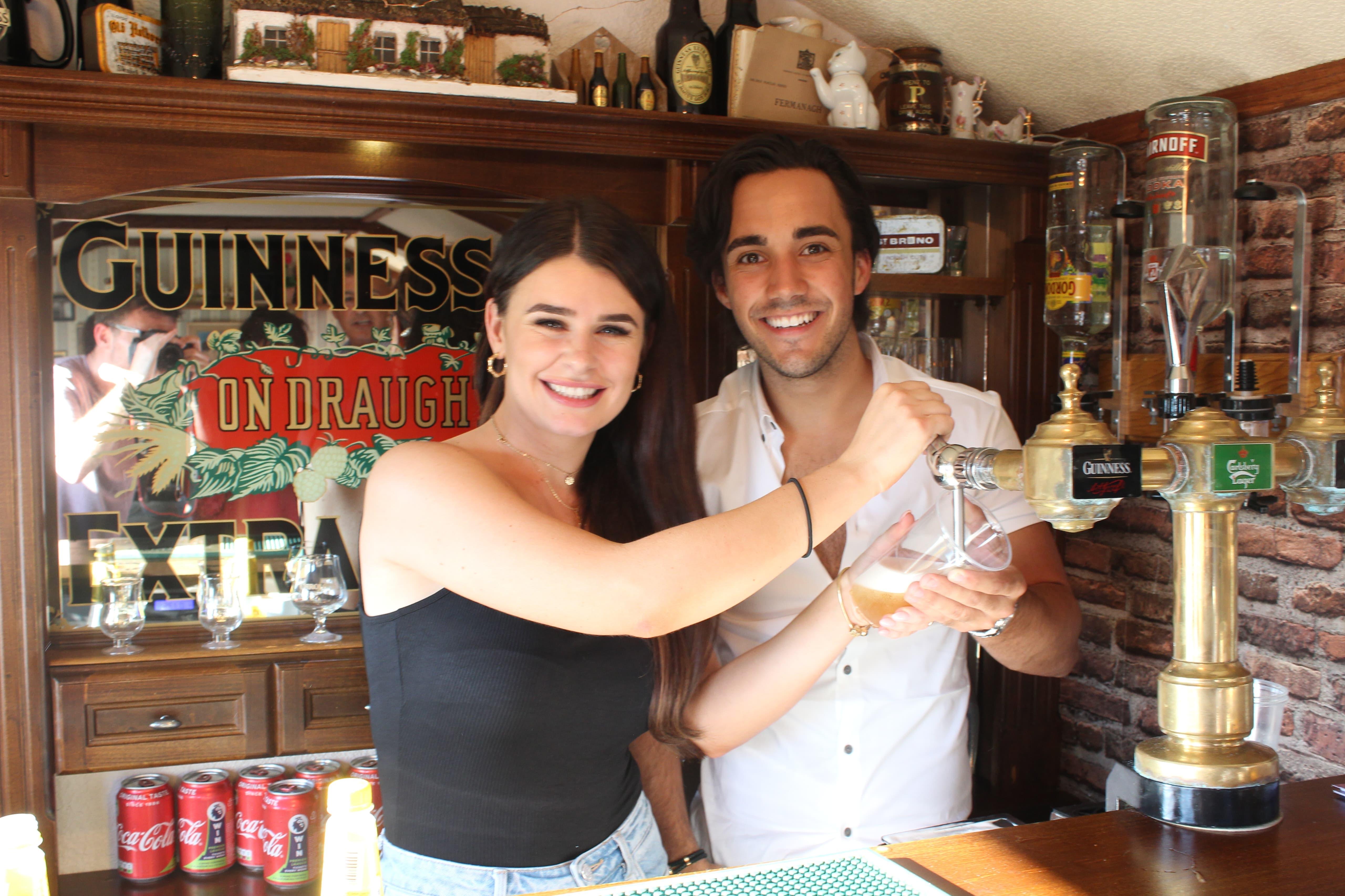 Couple pulling a pint inside The Hidden Naggin