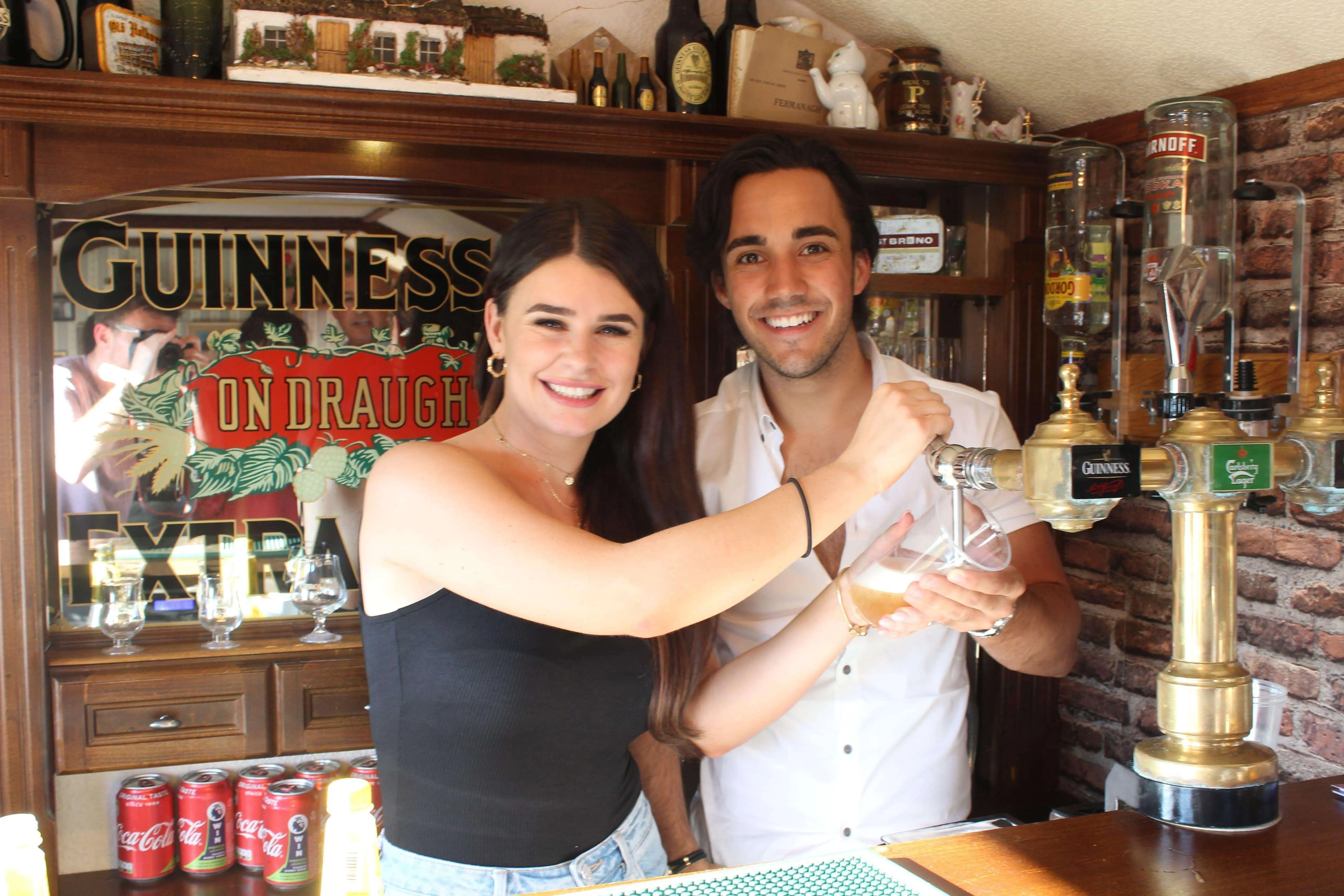 Couple pulling a pint inside The Hidden Naggin
