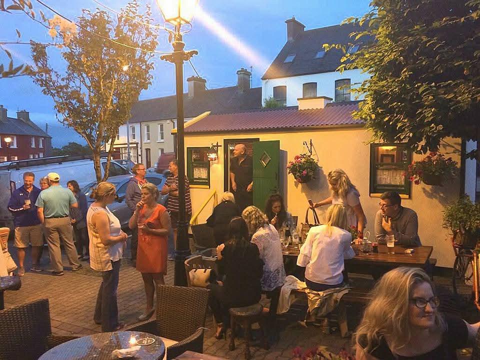 Evening crowd around The Hidden Naggin in a courtyard
