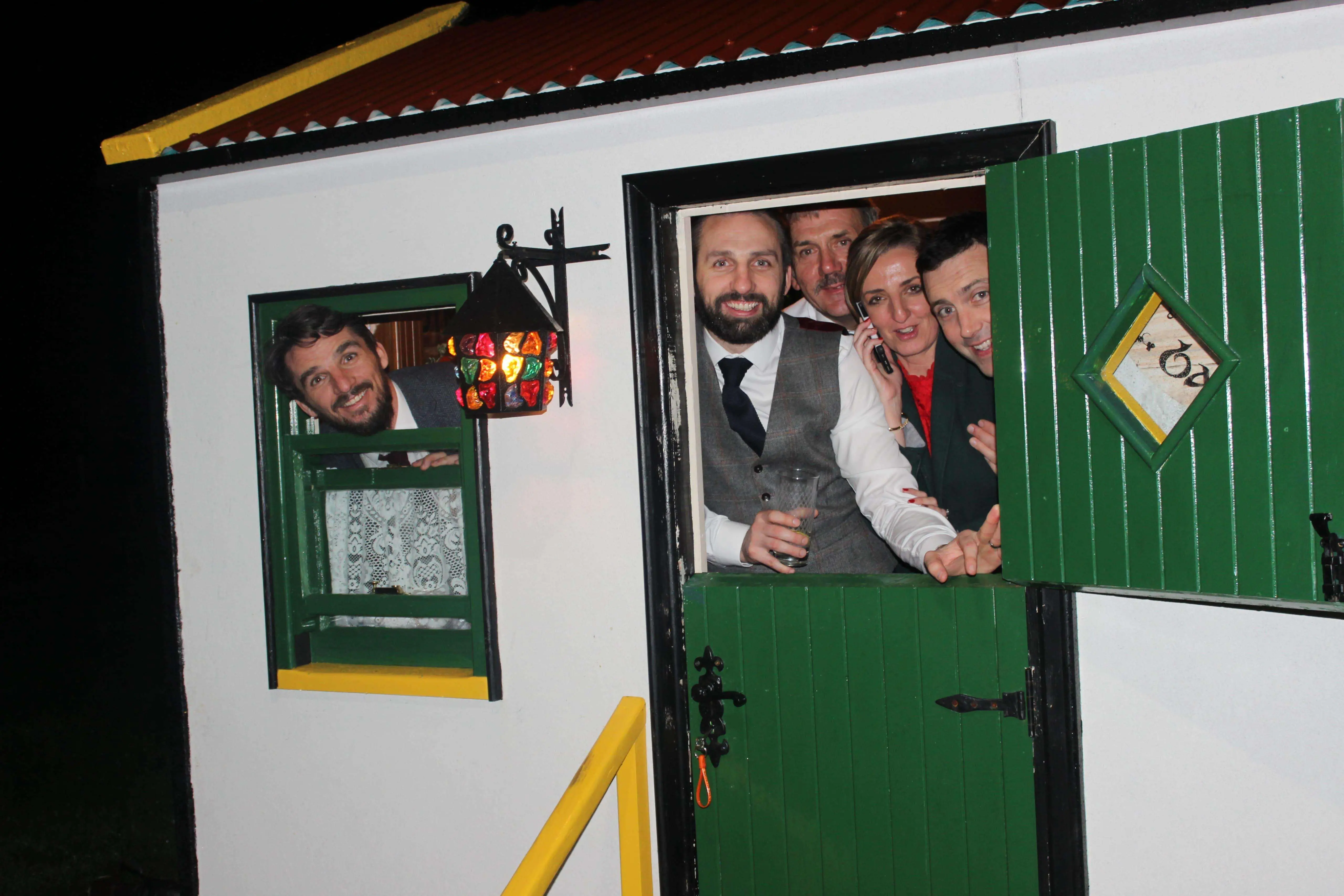 Guests at the doorway of The Hidden Naggin at night