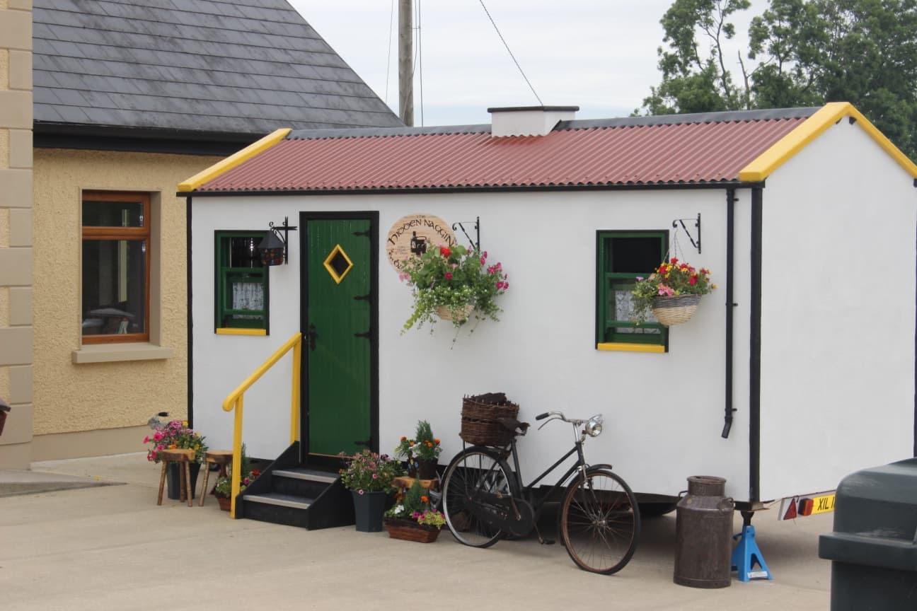 Side view of The Hidden Naggin with bicycle and flower baskets