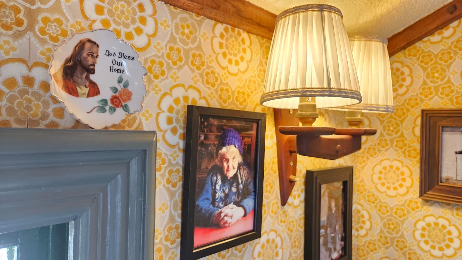 Lamps and family photos on retro wallpaper inside