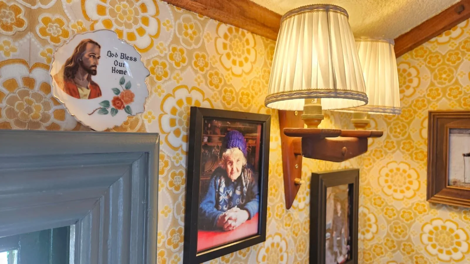 Lamps and family photos on retro wallpaper inside