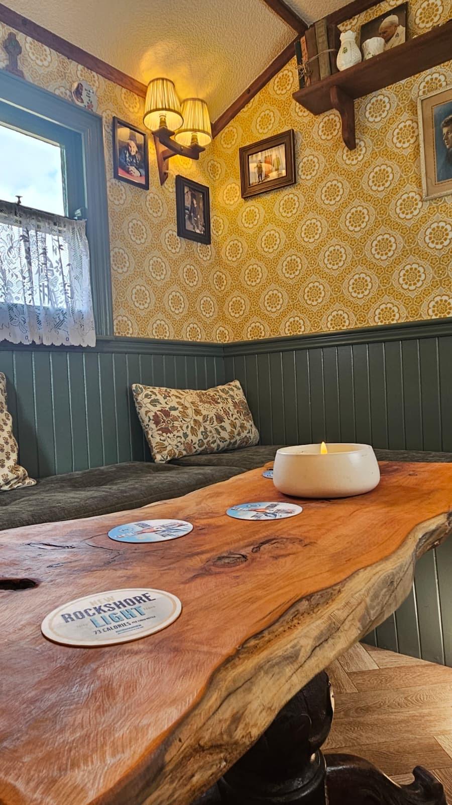Lounge table and candle inside The Hidden Naggin