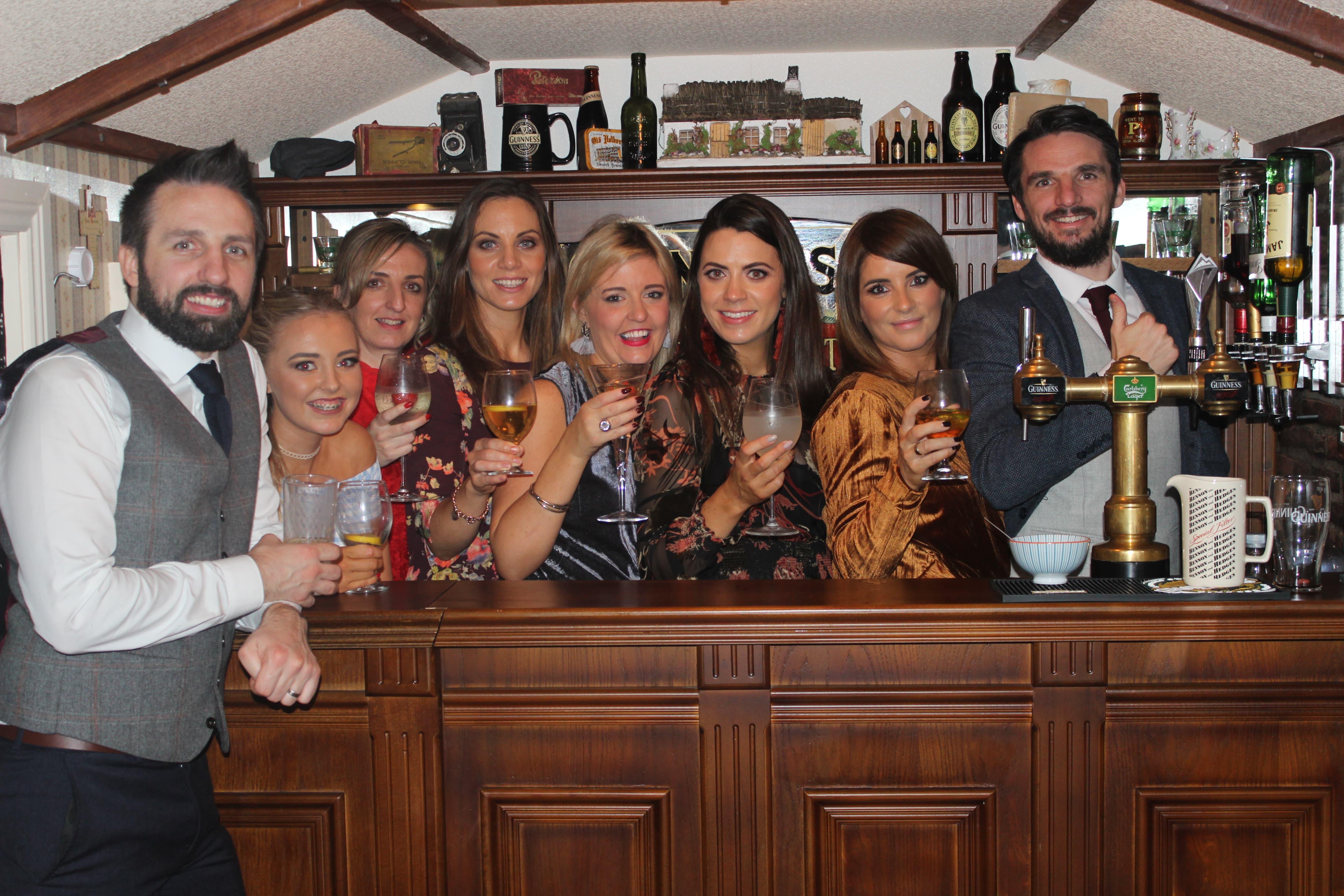 Party group gathered at the bar inside The Hidden Naggin
